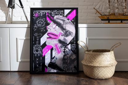 Framed The Emptiness Machine poster with vibrant pink tones, a cyborg figure, and fine marker textures, placed in a room with a basket and vintage sailor boat on a shelf.