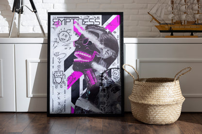 Framed The Emptiness Machine poster with a white background, vibrant pink elements, and hand-drawn textures, placed in a room with a basket and vintage sailor boat on a shelf.